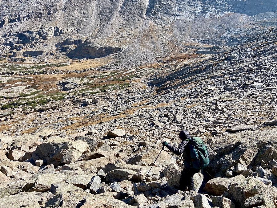 My husband hiking down loose boulders, carefully watching his step!