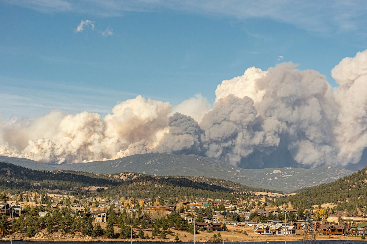 Photo: Smoke billows above Estes Park as the Cameron Peak Fire grew on a windy day in northern Colorado. Dawn Wilson