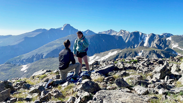 Image of a man proposing marriage to his girlfriend in  Rocky Mountain National Park