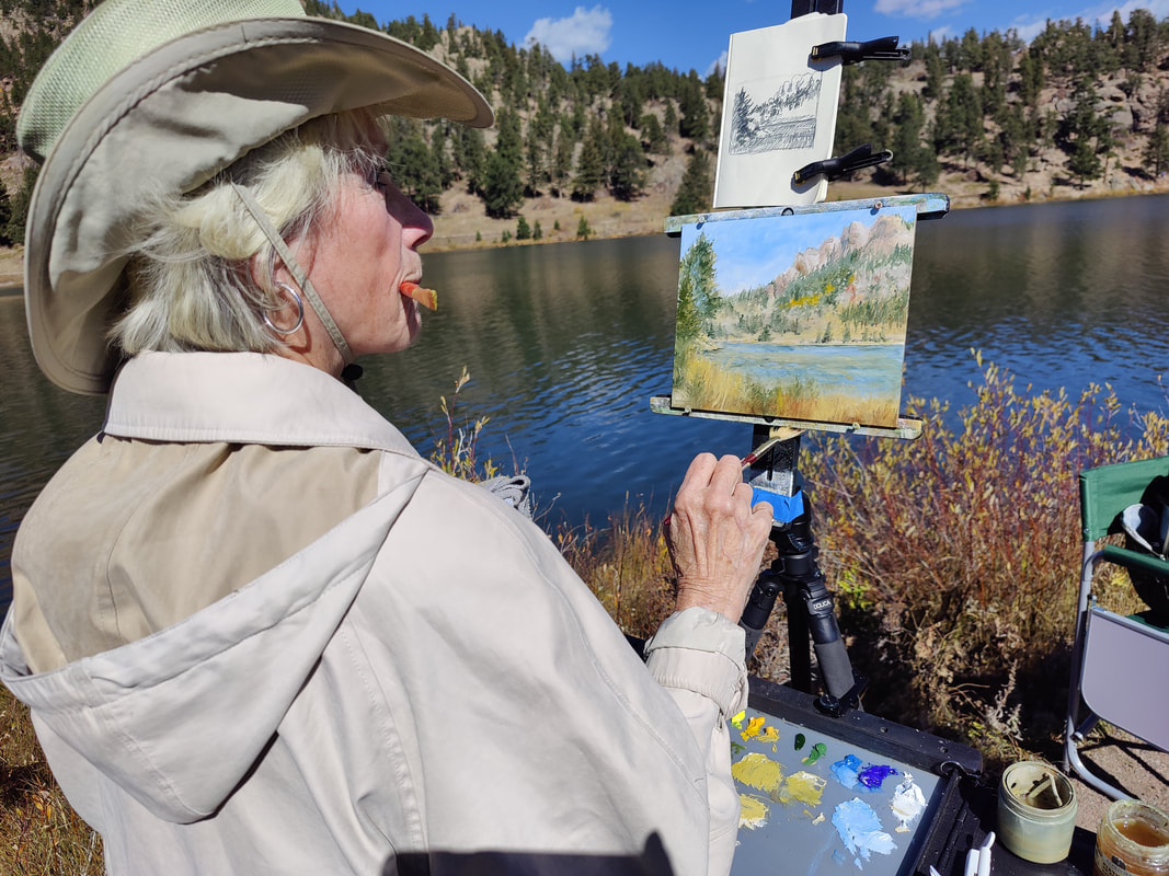 Pat Sebern paints at Lily Lake in Rocky Mountain National Park